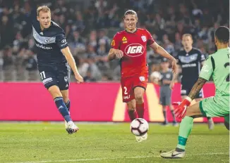  ??  ?? Victory’s Ola Toivonen beats Adelaide United goalkeeper Paul Izzo. Picture: AAP