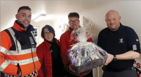  ??  ?? Jean and Tom from the junior lifeguard instructor­s at gym plus, presenting a Christmas hamper to the crew of the Drogheda Coast Guard unit for helping the children through out the year in all aspects of water safety.