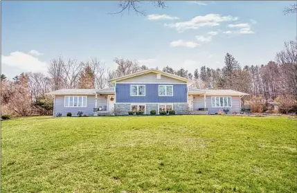  ?? Photos by Emotivo Production­s ?? Exterior of 49A Bradt Road in Rexford, which sits on just under one acre. At left is the living area.