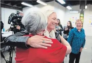  ?? JUSTIN TANG THE CANADIAN PRESS ?? Catherine McKenna hugs a member of her team after speaking to reporters about the slur.