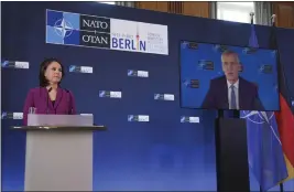  ?? MICHAEL SOHN — THE ASSOCIATED PRESS ?? German Foreign Minister Annalena Baerbock listens to NATO Secretary General Jens Stoltenber­g speaking through a video link on Sunday in Berlin.