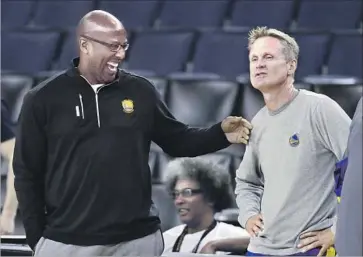  ?? Marcio Jose Sanchez Associated Press ?? GOLDEN STATE COACH Steve Kerr, right, has not been on the Warriors’ bench since Game 2 in the first round of the playoffs because of back pain. Assistant Mike Brown, left, has coached the team in his absence.