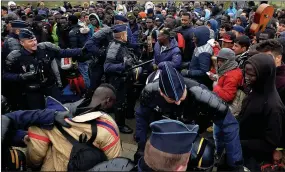  ??  ?? Clash: French police wielding truncheons try to break up fighting