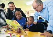  ?? Picture: EUGENE COETZEE ?? A WORD OR TWO: Volunteer Sibongile Mbedzi teaches Grade 2 pupil Emihle Makasi 7, how to spell. With them at the new Literacy Centre in Uitenhage are VW representa­tive Vernon Naidoo and mayor Athol Trollip