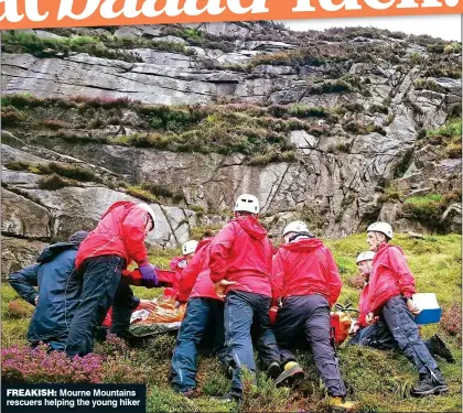  ??  ?? freakish: Mourne Mountains rescuers helping the young hiker