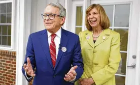  ?? PAUL VERNON / ASSOCIATED PRESS ?? Gov. Mike DeWine and first lady Fran DeWine leave their polling place after voting in Cedarville May 3. According to ethics disclosure­s that were due on Monday, DeWine owns stock in Intel.