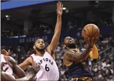  ??  ?? Cleveland Cavaliers guard Kyrie Irving (right) goes up to shoot past Toronto Raptors guard Cory Joseph during the second half of Game 4 of a second-round NBA basketball playoff series Sunday in Toronto. AP PHOTO