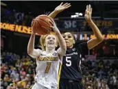  ?? Colin E. Braley / Associated Press ?? Lauren Hansen, who hit a buzzer-beating layup to lift Missouri past South Carolina, drives on Victaria Saxton.