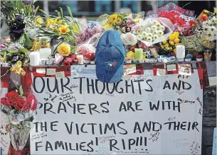  ?? COLE BURSTON THE CANADIAN PRESS ?? Tributes at a memorial at Yonge Street and Finch Avenue in Toronto for the victims of Monday's deadly van attack.