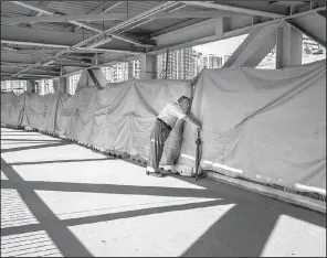  ?? New York Times/LAM YIK FEI ?? The Hong Kong constructi­on site for a terminal serving a planned 85-mile express rail line connecting Hong Kong with the Chinese cities of Shenzhen and Guangzhou is seen in late May.