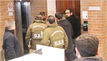  ??  ?? Chilean police officers are seen during the confiscati­on of the documents inside the office of the Ecclesiast­ical Court of the archdioces­e of Santiago, Chile. — Reuters photo