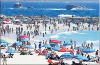  ??  ?? CAPE TOWN: Camps Bay main beach was covered in blue and red umbrellas as hundreds of people enjoyed the warm weather.