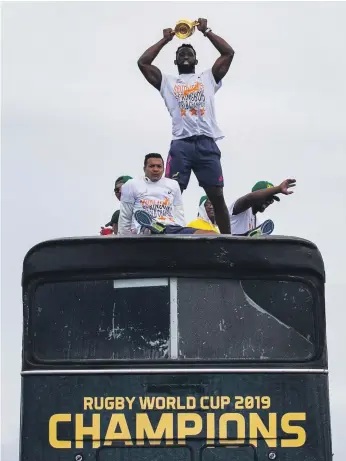  ?? AFP ?? South Africa captain Siya Kolisi holds the Webb Ellis Trophy during the Rugby World Cup winners’ parade through the streets of his home city of Zwide, near Port Elizabeth