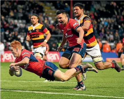  ?? PHOTO: PHOTOSPORT ?? Halfback Finlay Christie launches himself across the line to score in Tasman’s opening round NPC win over Waikato.