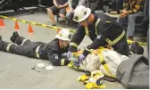  ??  ?? Kamin Bergstrom (left) and Mike Nelson of Nutrien Rocanville perform first aid on an injured individual.