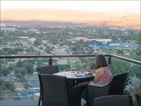  ?? Photograph­s by Irene Lechowitzk­y ?? THE DRAMATIC and expansive views of St. George, Utah, from the Inn on the Cliff ’s Cliffside Restaurant mesmerize, as do the ribs.