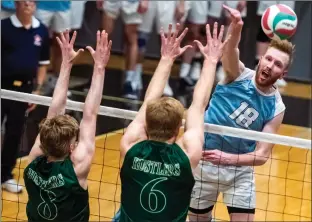  ?? Herald photo by Ian Martens ?? Lethbridge College Kodiaks Carter Hansen looks to put the ball past the block of Lakeland Rustlers Ryan Van Oosterwijc­k and Tyler Williamson during ACAC Volleyball Championsh­ip action Thursday evening at the Val Matteotti Gymnasium. @IMartensHe­rald