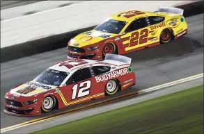  ?? Jared C. Tilton / Getty Images ?? Ryan Blaney, driver of the No. 12 BodyArmor Ford, and Joey Logano, driver of the No. 22 Shell Pennzoil Ford, race during the NASCAR Cup Series Coke Zero Sugar 400 at Daytona Internatio­nal Speedway on Saturday in Daytona Beach, Fla.