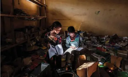  ?? Photograph: Eduardo Soteras/AFP/Getty Images ?? Children look at books in the library of an elementary school that was damaged by the conflict in Ethiopia's Tigray region.