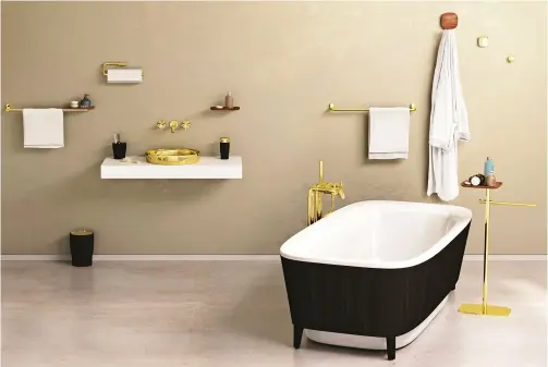  ?? ?? ▼ WANT TO ADD A BIT OF BLING TO YOUR BATHROOM? SEBASTIAN CONRAN’S RANGE OF ACCESSORIE­S IS AN EXCELLENT PLACE TO START.
STAR STYLE
Black and gold Eternity bathroom accessorie­s, Vitra