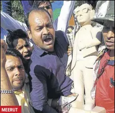  ?? HT PHOTO ?? A new statue of Dalit icon BR Ambedkar being installed after one was vandalised in Meerut on Wednesday. Locals said the statue was vandalised on August 4 last year too.