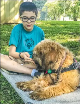  ?? Courtesy photo ?? Wyatt McLean and Gia, his potential service dog, visit in North Carolina.