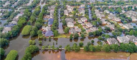  ?? Mark Mulligan/Staff file photo ?? The Canyon Gate neighborho­od of Cinco Ranch is filled by floodwater from Barker Reservoir on Sept. 2, 2017, in Houston.