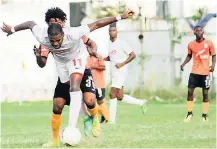  ?? SHORN HECTOR ?? UWI FC player Elton Thompson (foreground) shields the ball from Tivoli Gardens’ Tevin Shaw during their Red Stripe Premier League contest at the Edward Seaga Sports Complex yesterday. Tivoli won the game 3-2.