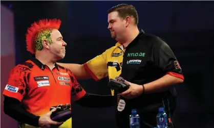  ??  ?? Gabriel Clemens (right) beat the defending champion, Peter Wright, 4-3 at the PDC world championsh­ip. Photograph: Luke Walker/Getty Images