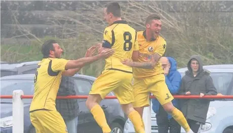  ?? John Rooney ?? Kev Pollard ( centre) celebrates his opening goal for Widnes FC in their 2-1 victory over Chadderton on Easter Monday with teammates Mike Burke ( left) and River Humphreys.