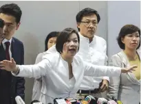  ?? — AFP ?? HONG KONG: Pro-Beijing legislator Priscilla Leung (center) arrives at a press conference in Hong Kong, following a ruling by Beijing on two elected pro-independen­ce lawmakers from the city’s legislatur­e.
