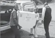  ?? KENNY KATOMBE / REUTERS ?? Officials carry Ebola vaccines in Kinshasa, Democratic Republic of Congo, on Wednesday.