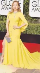  ??  ?? Jennifer Lopez wears a yellow gown with 200 carats of Harry Winston diamonds.