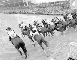  ?? ANDY LYONS/GETTY IMAGES ?? The field leaves the gate at the start of Saturday’s 144th running of the Kentucky Derby at Churchill Downs, where Justify emerged as champion.