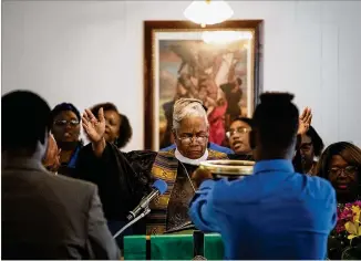  ?? ELISSA BENZIE / FOR THE AJC ?? The Rev. Willie Beverly conducts Sunday’s service at Bethel African Methodist Episcopal Church in Gainesvill­e, as supporters joined the church’s usual 40-member congregati­on in worship.