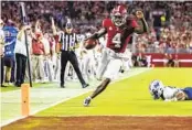  ?? VASHA HUNT AP ?? Alabama QB Jalen Milroe has 12 rushing TDs this season, including this one against Middle Tennessee.