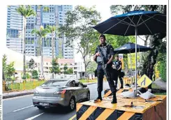  ??  ?? Armed police officers outside the Shangri-la hotel where Donald Trump is staying