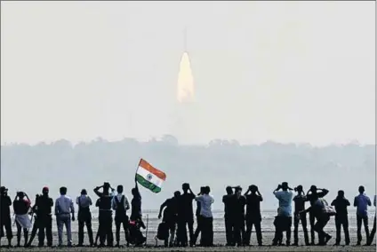  ?? Photo: Arun Sankar/AFP ?? Sky’s the limit: Indians watch the launch of a record 104 satellites from a single rocket at Sriharikot­a. Prime Minister Narendra Modi described the feat as ‘hitting a century in space technology’.