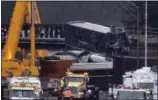  ?? ELAINE THOMPSON — THE ASSOCIATED PRESS ?? A damaged Amtrak train car is lowered from an overpass at the scene of Monday’s deadly train crash onto Interstate 5Tuesday in DuPont, Wash.