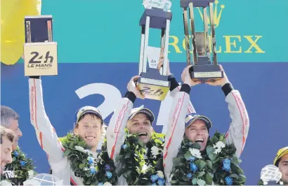  ?? Picture: EPA ?? GARLANDED. Germany’s Timo Bernhard (right) and New Zealanders Earl Bamber and Brendon Hartley celebrate on the podium after winning the Le Mans 24-Hour race for Porsche yesterday.