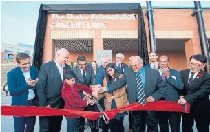  ?? PAULCALAND­RA.COM ?? Flato Developmen­ts president Shakir Rehmatulla­h, fourth from left, shares scissors with Markham Mayor Frank Scarpitti, second from left, and Premier Doug Ford, centre, at the ribbon-cutting ceremony for a new cancer clinic at the Markham Stouffvill­e Hospital.