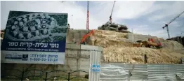  ?? (Amir Cohen/Reuters) ?? CRANES, TRUCKS and heavy equipment on a hill indicate constructi­on underway in Modi’in Illit on March 27.