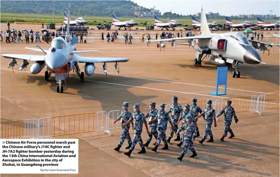  ?? Ng Han Guan/Associated Press ?? > Chinese Air Force personnel march past the Chinese military’s J10C fighter and JH-7A2 fighter bomber yesterday during the 13th China Internatio­nal Aviation and Aerospace Exhibition in the city of Zhuhai, in Guangdong province