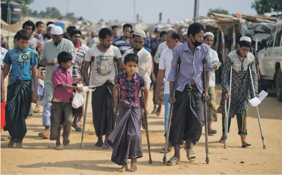  ??  ?? Rohingya refugees, including victims of rape and torture as well as those injured trying to escape, prepare yesterday to meet the UN Security Council team at the Kutupalong camp. The officials promised to work hard to resolve the crisis involving...