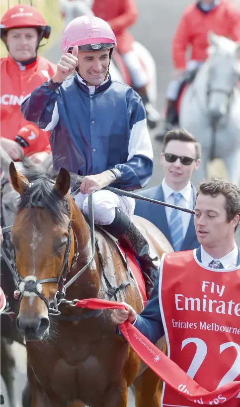  ?? AFP ?? Corey Brown, atop Rekindling, gives the crowd a thumbs up after winning the 157th Melbourne Cup at Flemington Racecourse on Tuesday. —