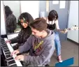  ?? WES BOWERS/NEWS-SENTINEL ?? McNair students Leah Cortez and Kayden Galvez play the piano while Lodi High School student Romina Herrera lays down the basslines as Karla With a K rehearses and original compositio­n for the Music Industry course of Summer High School Institute.