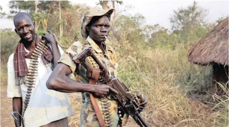  ?? AP ?? OPPOSITION soldiers pose for a picture on Tuesday while loading their guns in Panyume town, the headquarte­rs for the opposition in Central Equatoria state, in South Sudan. Since a fragile peace deal was signed in September 2018, South Sudan’s previously warring parties have been working to rebuild trust in some of the areas hardest hit by the war. |