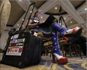  ?? PHOTOS BY MARK HUMPHREY — THE ASSOCIATED PRESS ?? Amy Hedtke of Waxahachie, Texas, takes notes as she listens during a session of the standing committee on rules at the Republican National Committee summer meeting, Thursday in Nashville, Tenn.