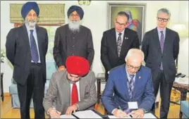  ?? HT PHOTO ?? (From left-standing) Punjab food and civil supplies minister Adaish Partap Singh Kairon, chief minister Parkash Singh Badal and Ontario agricultur­e minister Jeff Leal during signing of an MoU in Chandigarh.
