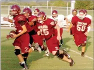  ?? MARK HUMPHREY ENTERPRISE-LEADER ?? Lincoln junior high quarterbac­k Tyler Brewer leads a convoy of junior Wolves during a pre-season scrimmage. Brewer led Lincoln to a 22-6 road win at Westville Thursday.